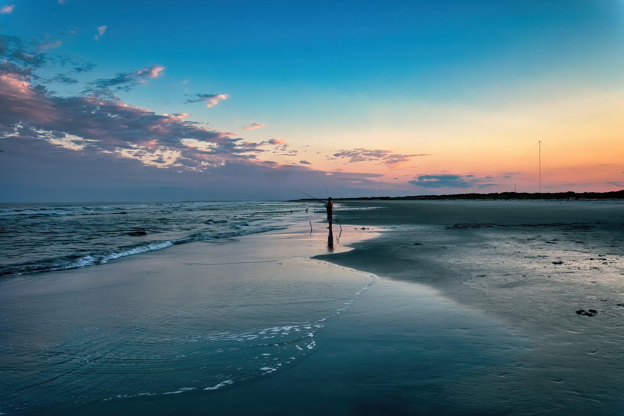 Fisherman on the beach at sunset. Taken in Wildwood, NJ.